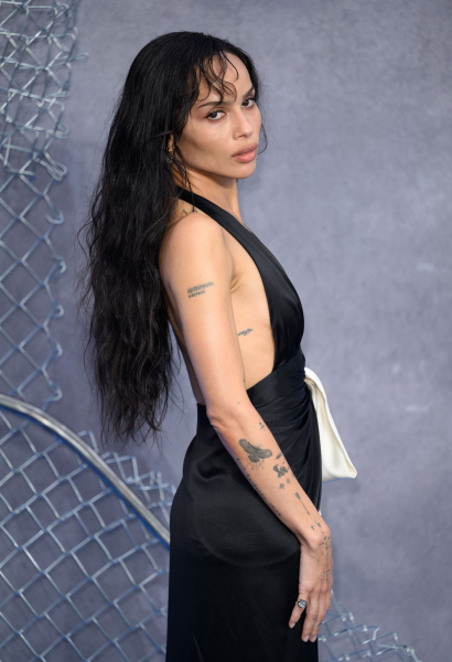 Zoë Kravitz posing in a black dress